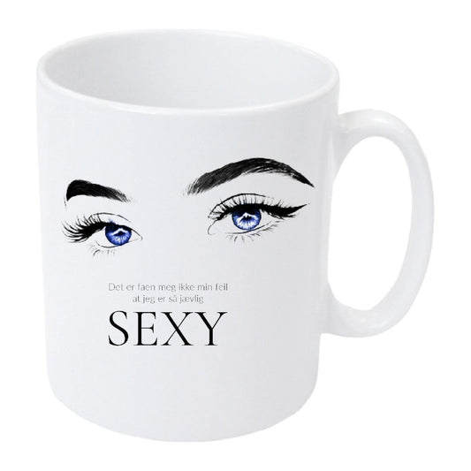 Kopp med dame øyne blå, med teksten " Det er faan meg ikke min feil at jeg er så jævlig sexy"